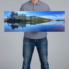 A man holds a 90x30cm panoramic canvas print