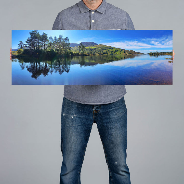 A man holds a 90x30cm panoramic canvas print