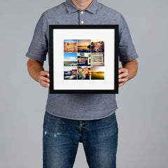 A man holds a black square frame containing a photo grid collage of nine small travel photographs against a plain gray background. The print is 20x20cm and the frame is 34x34cm. 